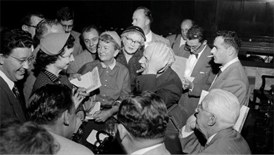 Dorothy Kilgallen surrounded by admiring fellow journalists at the Dr. Sam Sheppard trial. (Photo from Mark Shaw Collection)