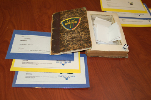 Players selected their “role” by drawing slips of paper from a hollowed out withdrawn book. Photo by Adam Alley.