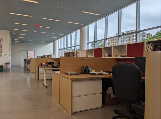 The natural light-filled, smaller administrative office area has fewer workstations but are of the same type used by all staff.