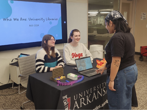 Kim Larsen, undergraduate engagement librarian, and Bekah Olson, engagement and instruction graduate assistant, at an example of the NSO table. Photo Courtesy of Megan York.