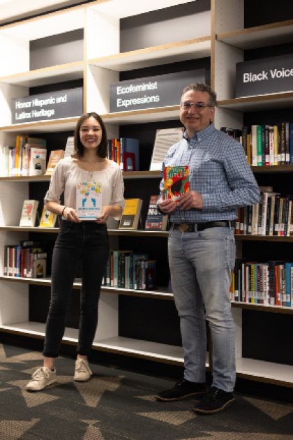 Kim Larsen, undergraduate engagement librarian, and Bekah Olson, engagement and instruction graduate assistant, at an example of the NSO table. Photo Courtesy of Megan York.