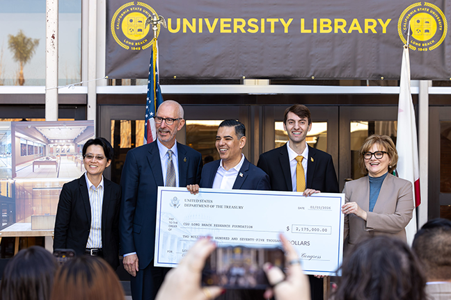 Rep. Robert Garcia (center) presented $2.175 million in federal funding to CSULB administration and Dean of Library Elizabeth Dill (right).