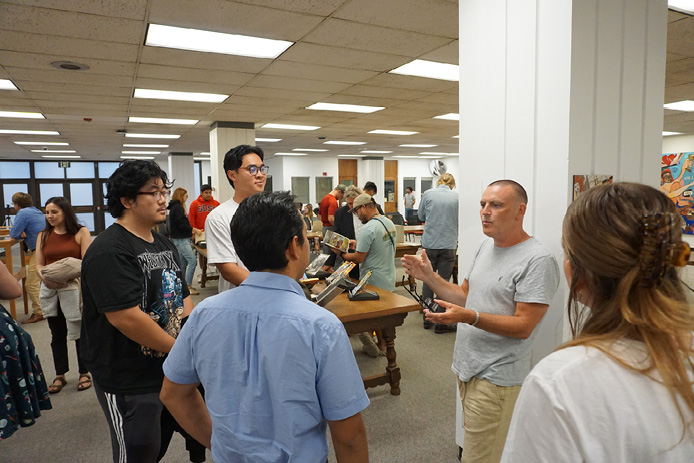 Scottish comic artist Vin Deighan (aka Frank Quitely) discusses the form and style of his art with attendees.